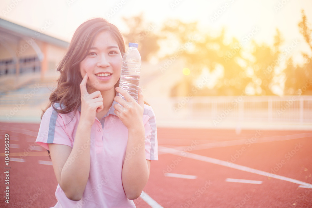 Sports beautiful woman on stadium drinking water Sports beautiful woman on stadium drinking water
