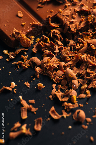 Many candy and chocolate chips on a black background