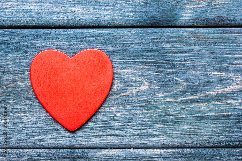 Red wooden heart on blue painted grunge wooden table. Red wooden heart on blue painted grunge wooden table.