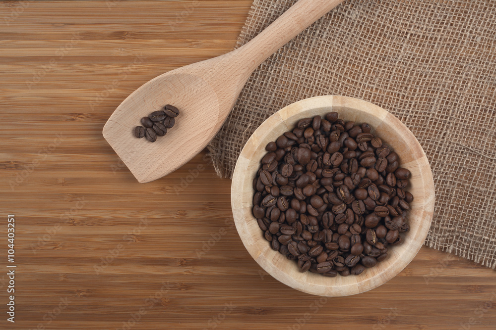 Coffee beans in bowl on wooden background Coffee beans in bowl on wooden background