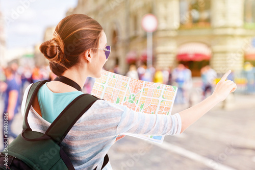 Traveler with map on the st...