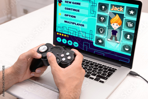 Young man playing computer ...