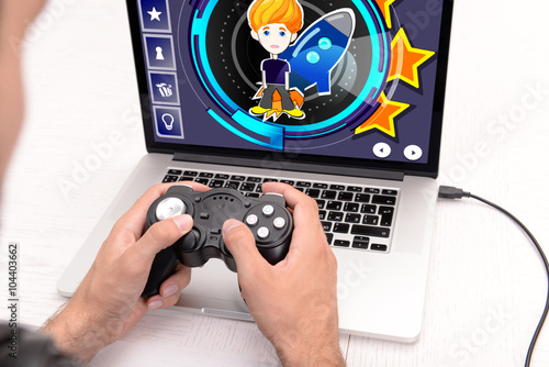 Young man playing computer ...