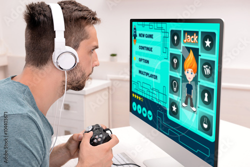 Young man playing computer ...