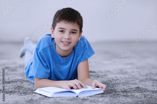 Little boy reading book on ...