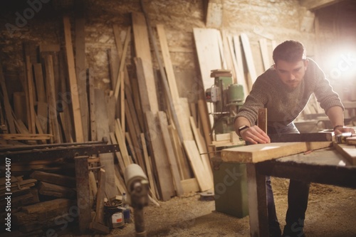 Carpenter working in workshop photo