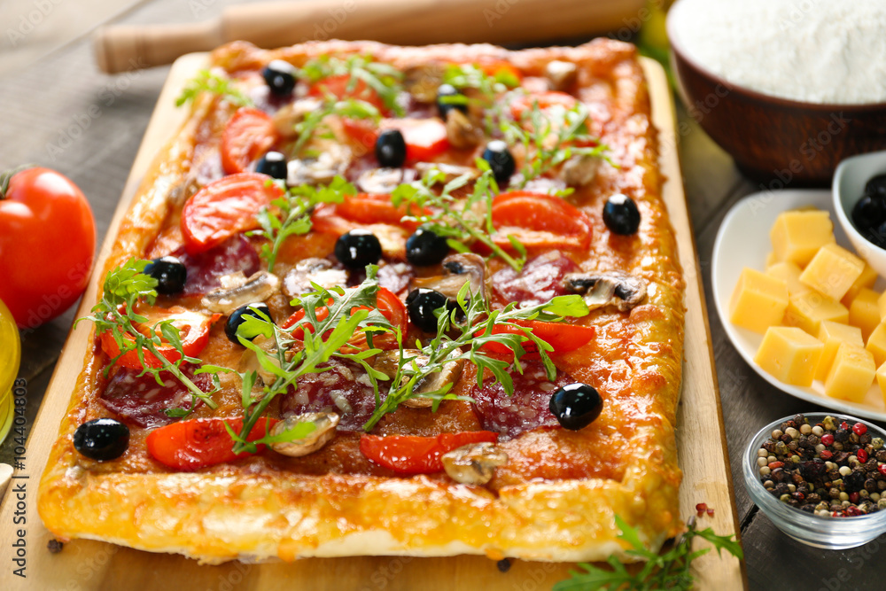 Rectangle delicious pizza and vegetables on the table Rectangle delicious pizza and vegetables on the table
