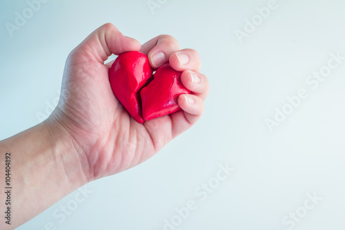 Female hands holding broken heart