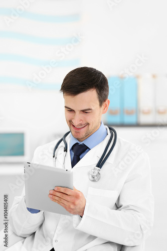 Doctor with tablet in office