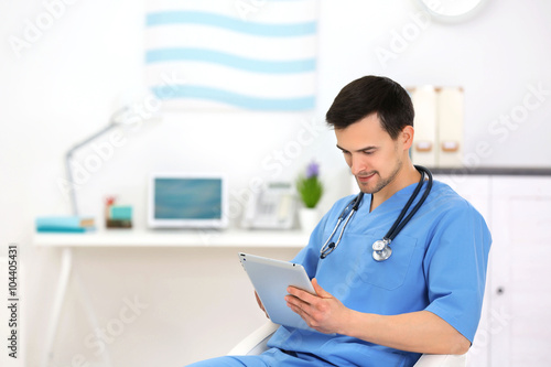 Doctor with tablet in office