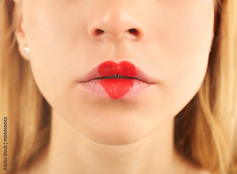 Sexy lips with coral heart shape paint, closeup
