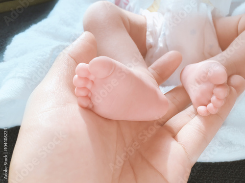 foot baby with hand
