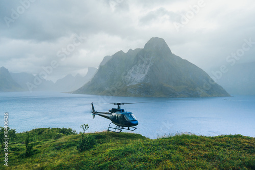 Helicopter in the great Norway mountains in cloudy weather. Reine, Lofotens