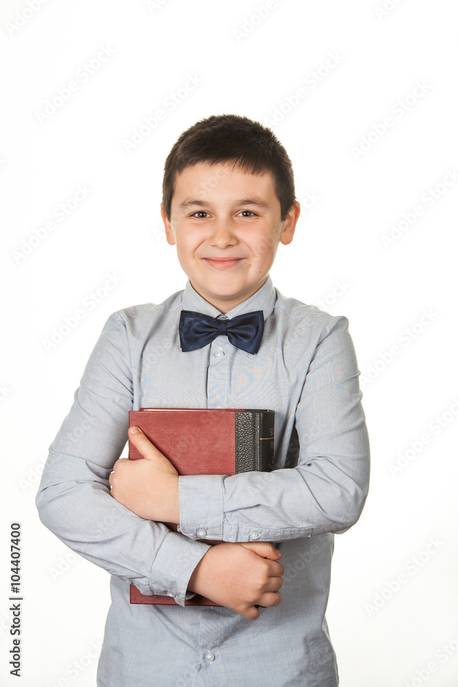 Portrait of a happy young boy, child, holding a red book, on whi Portrait of a happy young boy, child, holding a red book, on whi