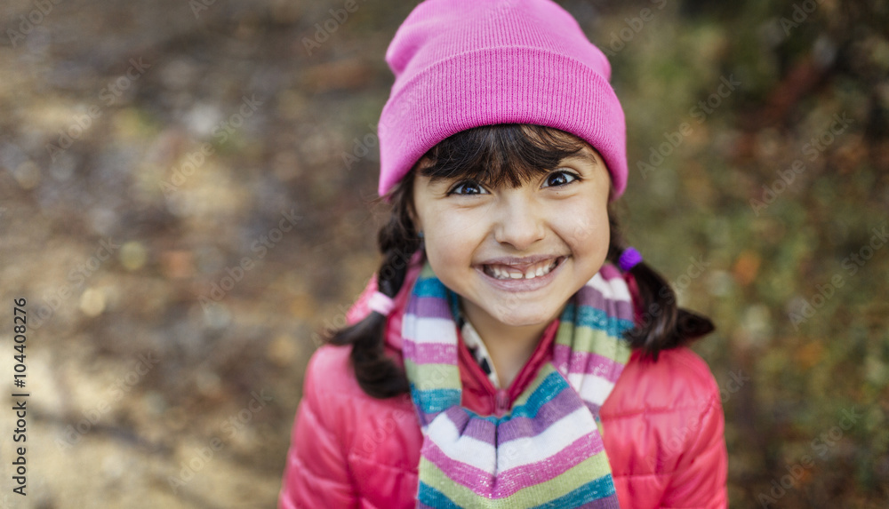 Portrait of grinning little girl wearing cap and scarf in autumn Portrait of grinning little girl wearing cap and scarf in autumn