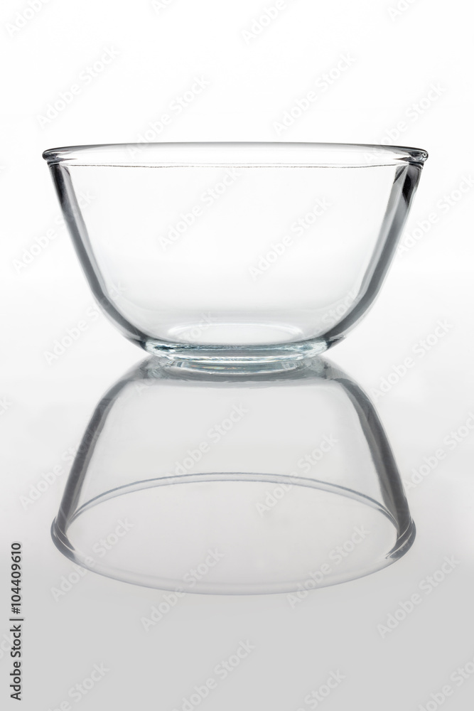 Glass transparent bowl on white background from side with reflection vertical composition Glass transparent bowl on white background from side with reflection vertical composition