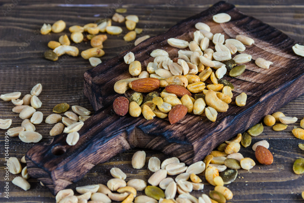 Scatterede nuts. Wooden background Scatterede nuts. Wooden background