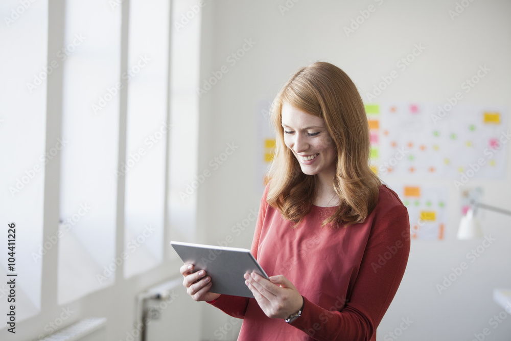 Young woman in office holding digital tablet Young woman in office holding digital tablet