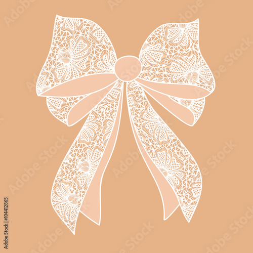 Decorative white lacy bow on beige background