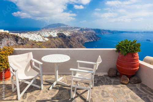 Table and chairs on roof with a panorama view on Santorini island  Greece.