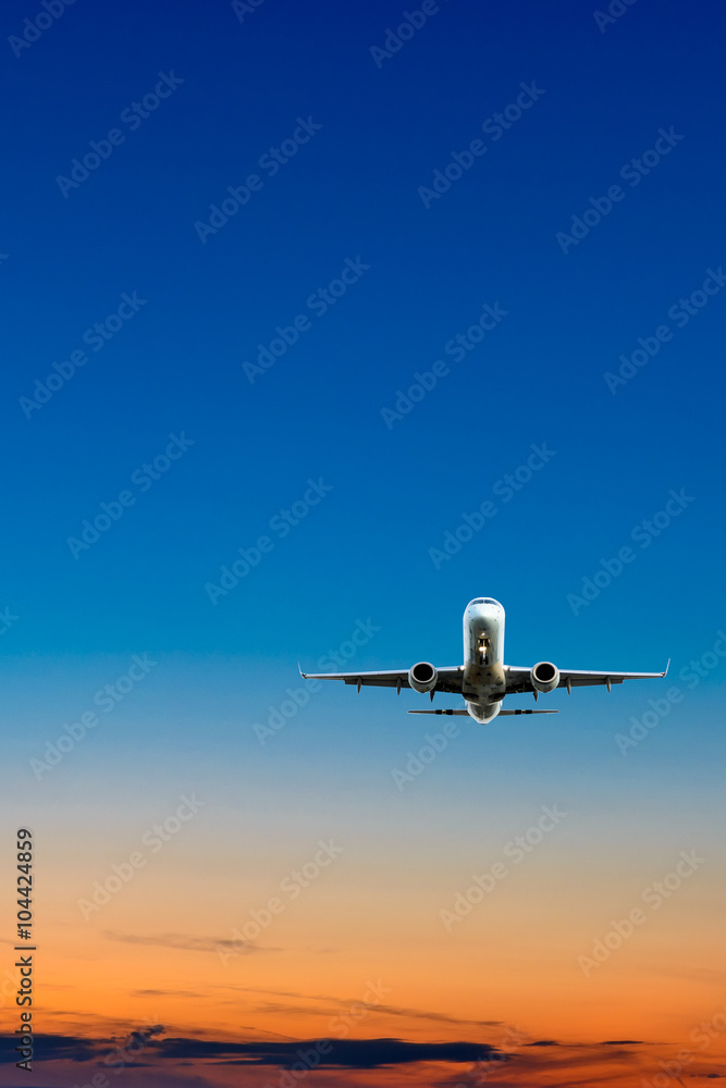 Sunset or sunrise (dawn, dusk ) flight of the airplane (jet) over beautiful sky and ocean.