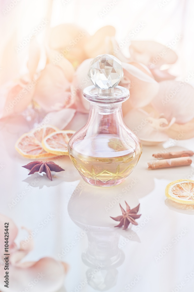 Perfume and aromatic oils bottle surrounded by flowers Perfume and aromatic oils bottle surrounded by flowers