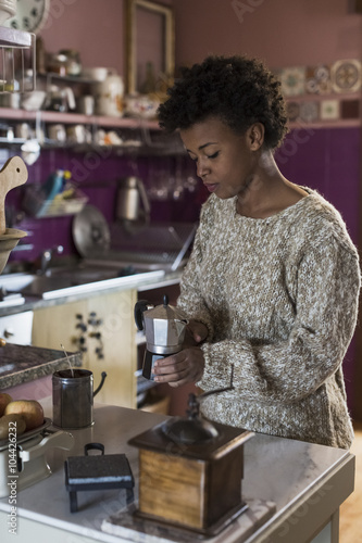 Wallpaper Mural Young woman in kitchen preparing coffee Torontodigital.ca