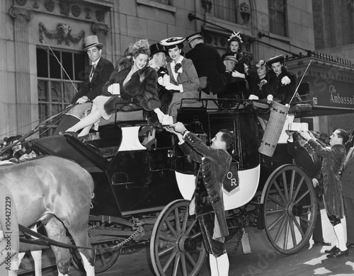 Wealthy group of people in horse drawn carriage 