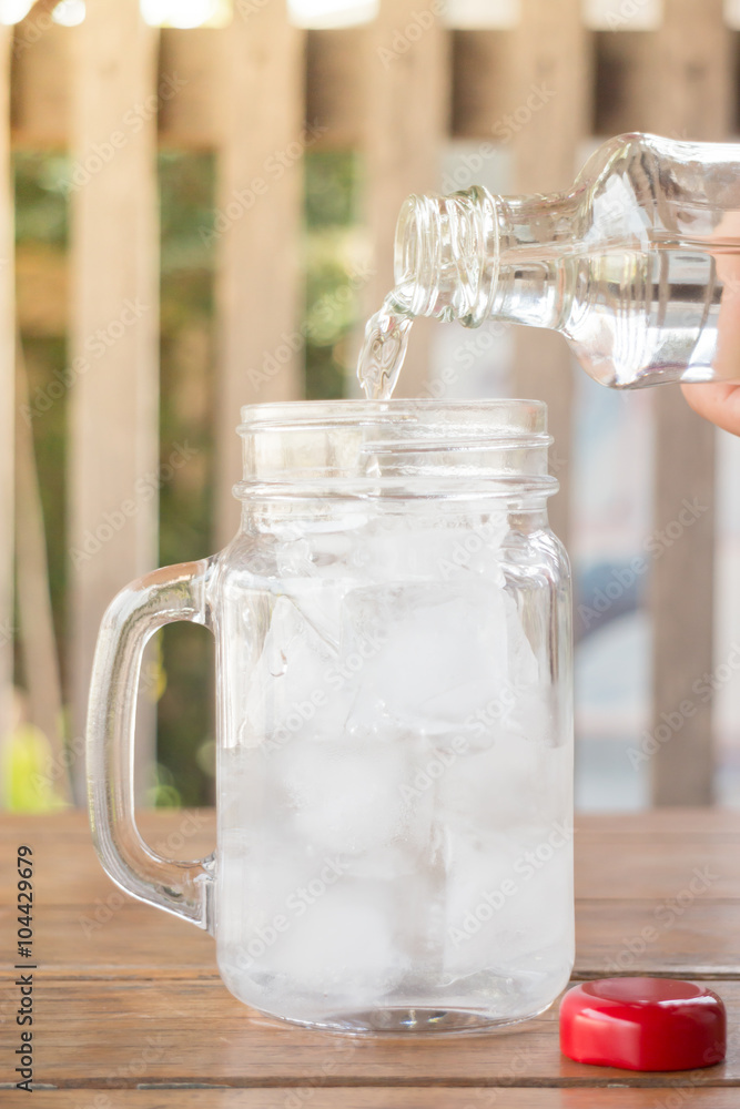 Drinking water is poured into iced glass Drinking water is poured into iced glass