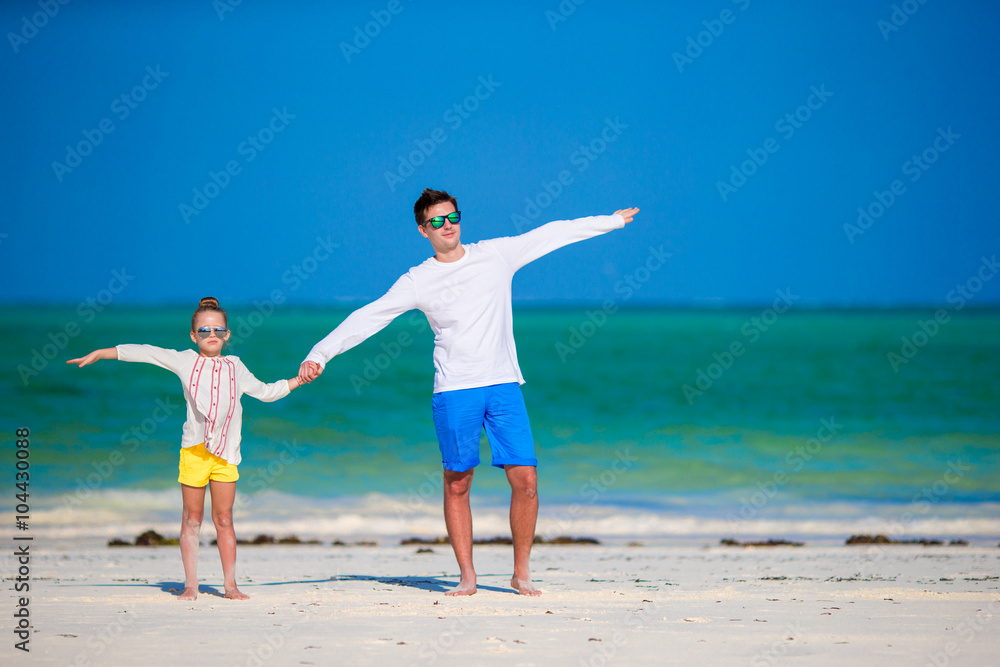 Little girl and dad during tropical beach vacation Little girl and dad during tropical beach vacation