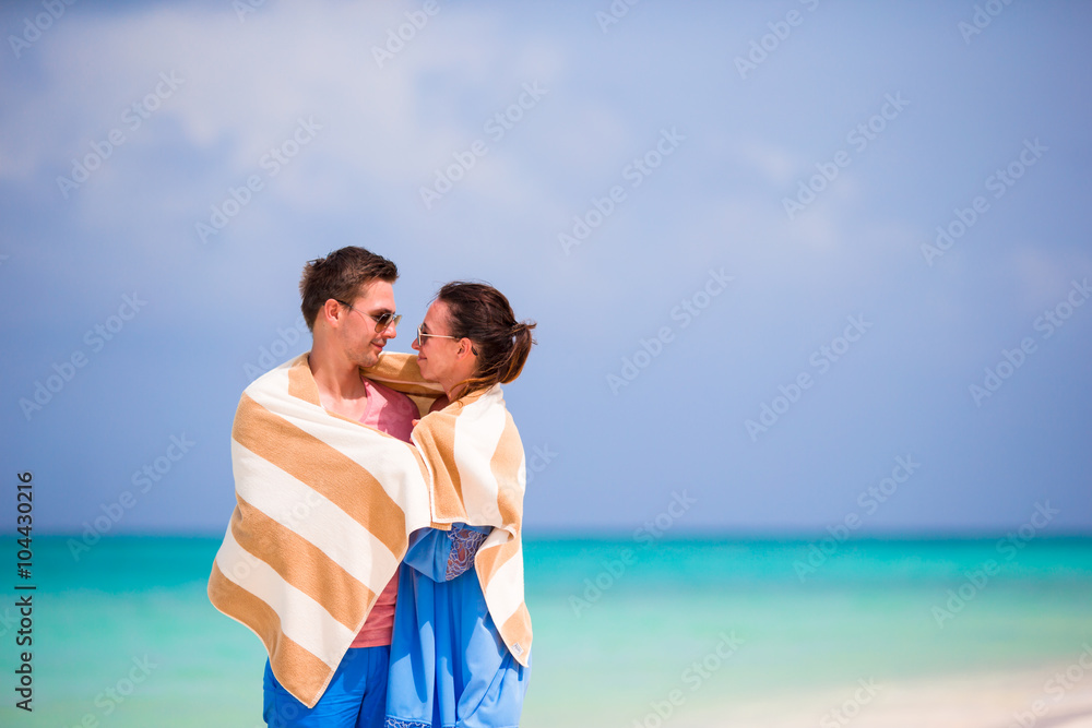 Young couple on white beach at summer vacation Young couple on white beach at summer vacation