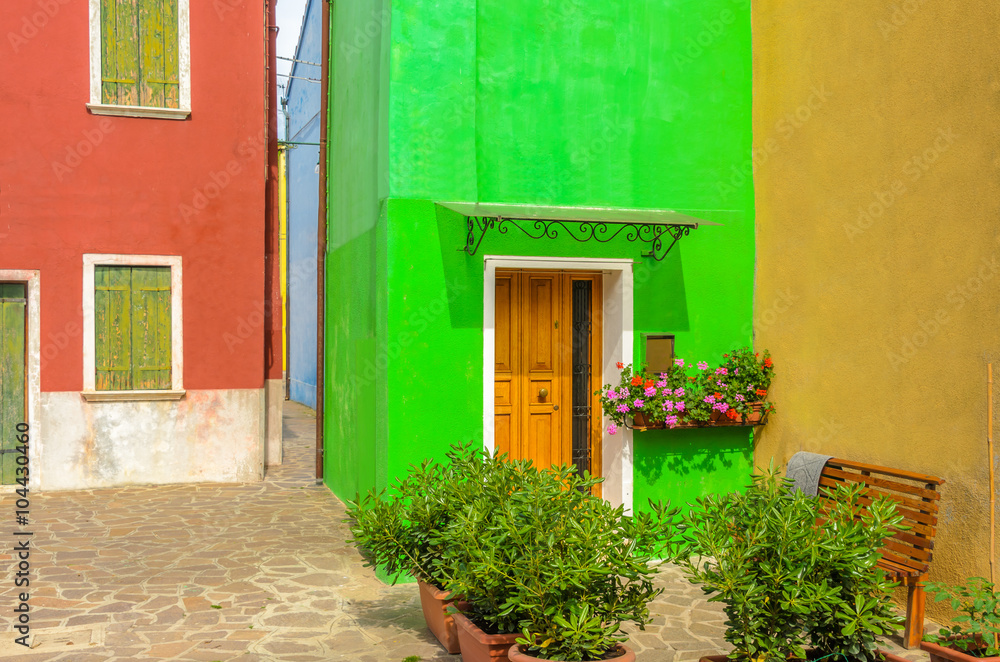 Entrance of a colorful apartment building in Burano, Venice, Italy.