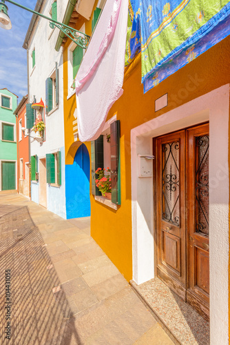 Entrance of a colorful apartment building in Burano, Venice, Italy.