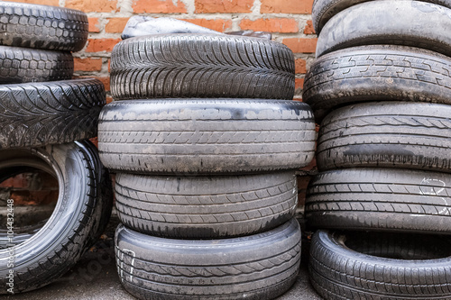 used tires at red brick wall background
