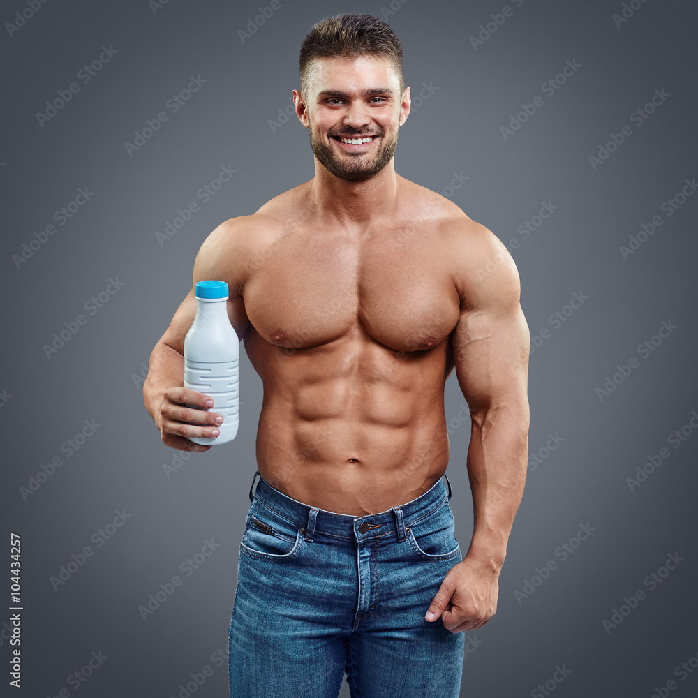 Fototapeta premium milk bottle in the hands of a sports person