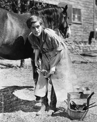 Woman shoeing horse 