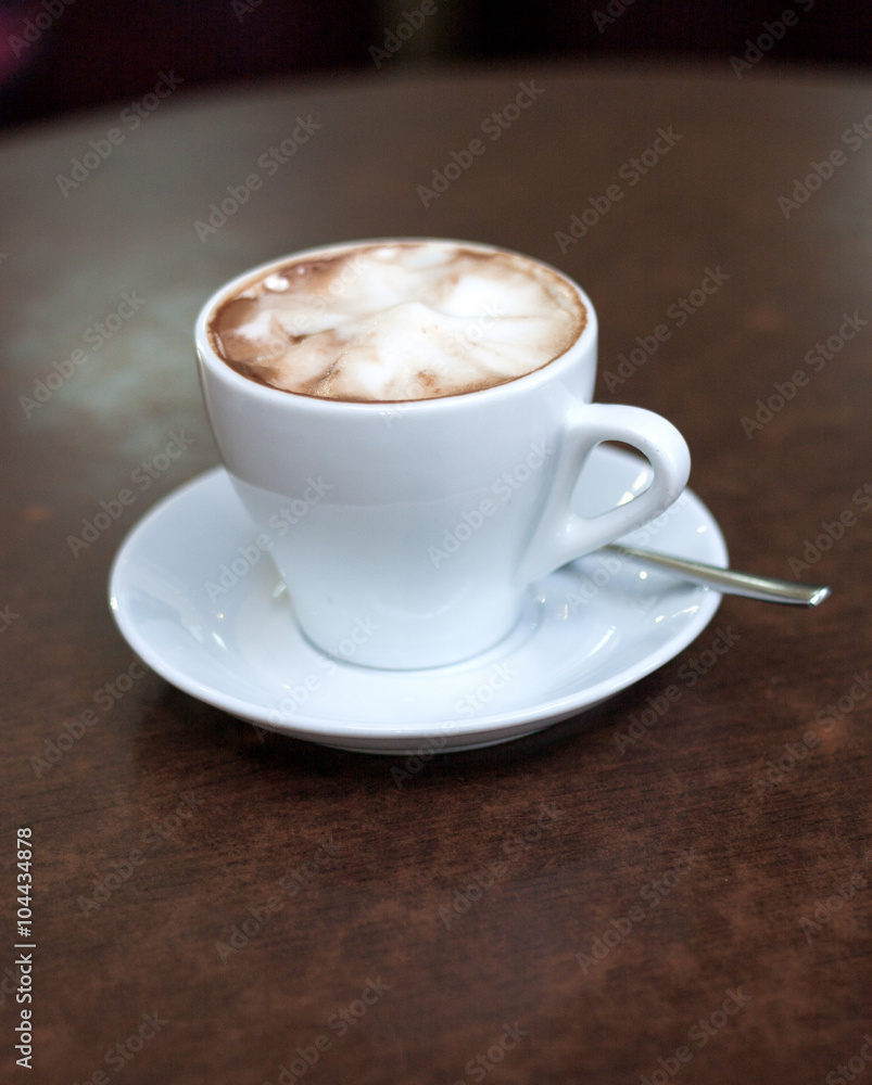 Cappuccino in a white cup on the table Cappuccino in a white cup on the table