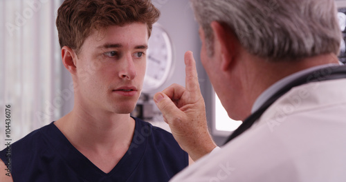 Portrait of young caucasian sports athlete having eyesight check