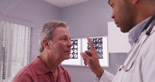 Canvastavla African-american doctor examining head trauma of senior caucasia
