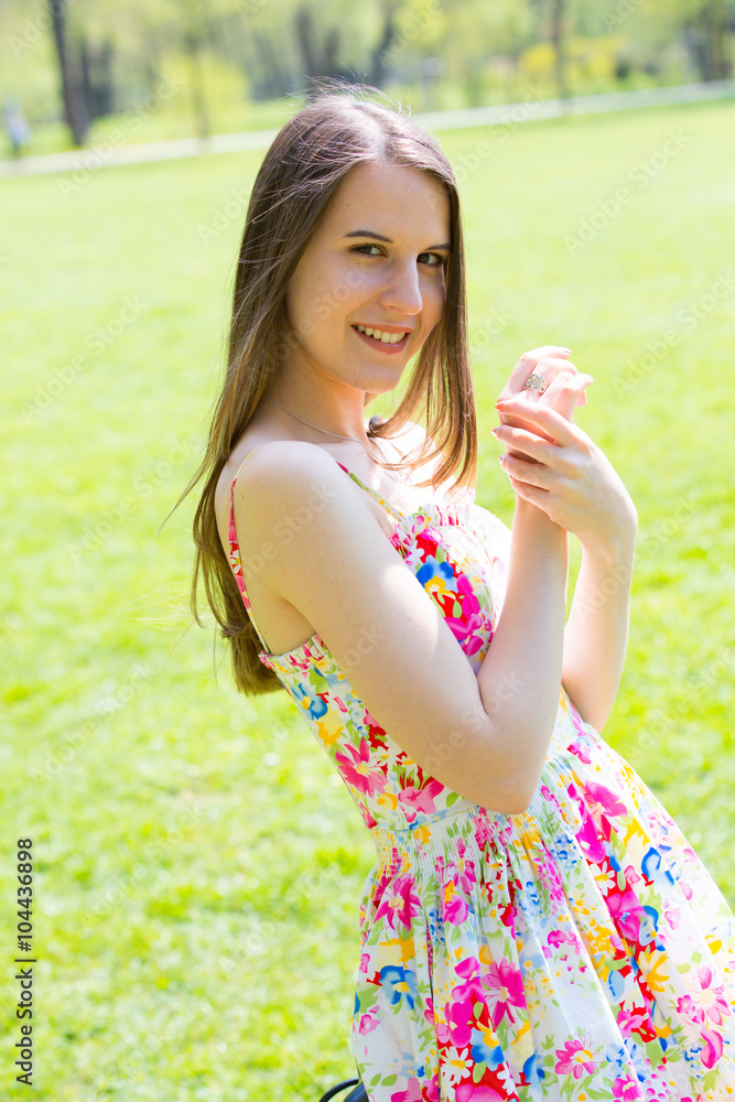 Young pretty woman with long hair in park
