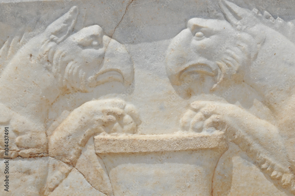 Detail of ancient roman sculpture of two griffons guarding treasure