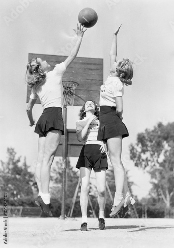 Group of young woman playing basketball 