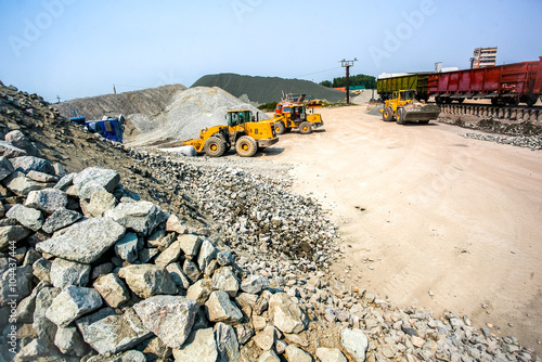 Yellow bulldozer working in quarry