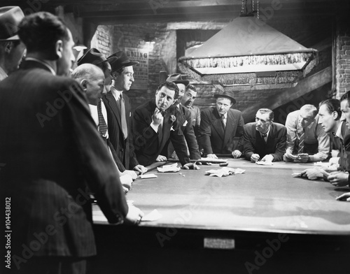 Mobsters meeting around pool table 