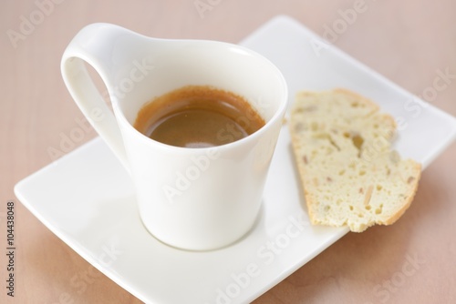 Cup of espresso with biscuit as snack