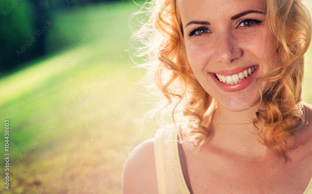 Blond woman, curly hair in green nature. Sunny summer Blond woman, curly hair in green nature. Sunny summer