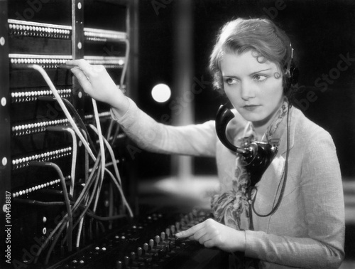 Young woman working as a telephone operator  photo