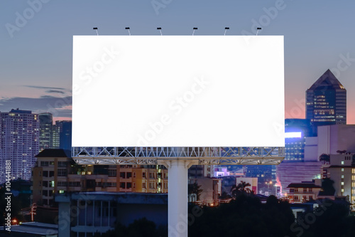 Blank billboard for advertising with cityscape sunset background.