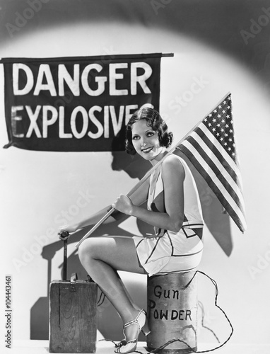 Portrait of woman with American flag and explosives 