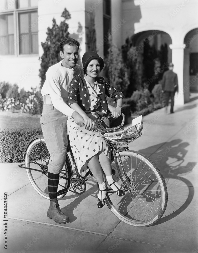 Portrait of couple on bicycle together 